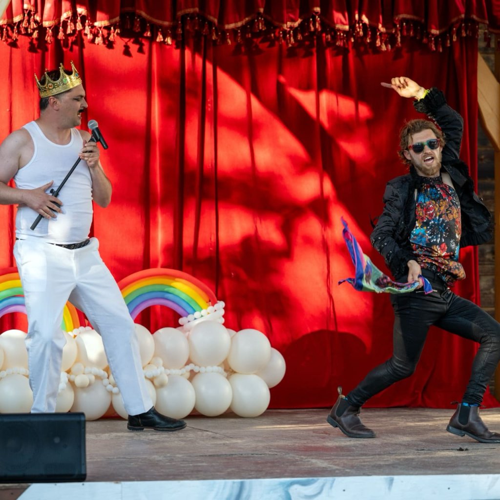 Archive photo of a Round Back performance. Two performers dance on stage.
