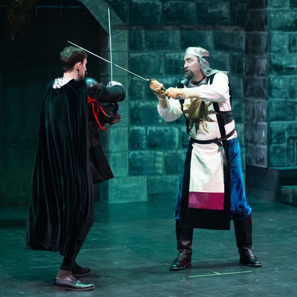 Spamalot archive photo. King Arthur and the Black Knight engage in a sword fight.