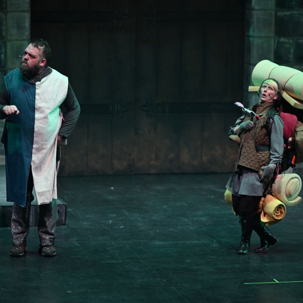 Spamalot archive photo. Concorde is hit in the chest with an arrow while Lancelot looks on.